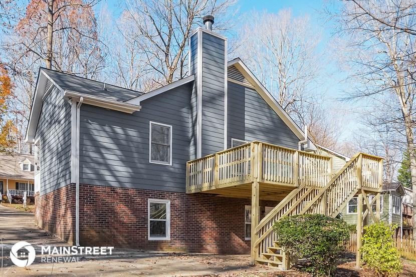 a home with a deck on the side of a house