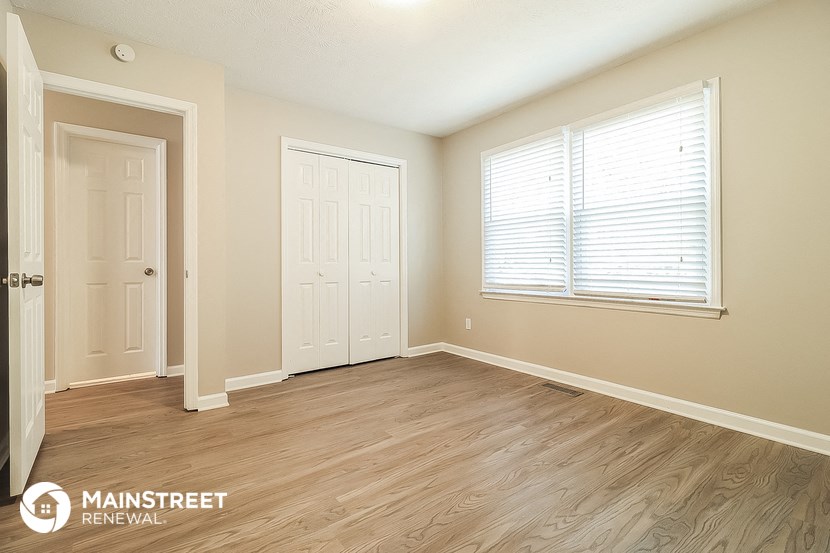 the master bedroom of this 2500 sq ft home has a hardwood floor