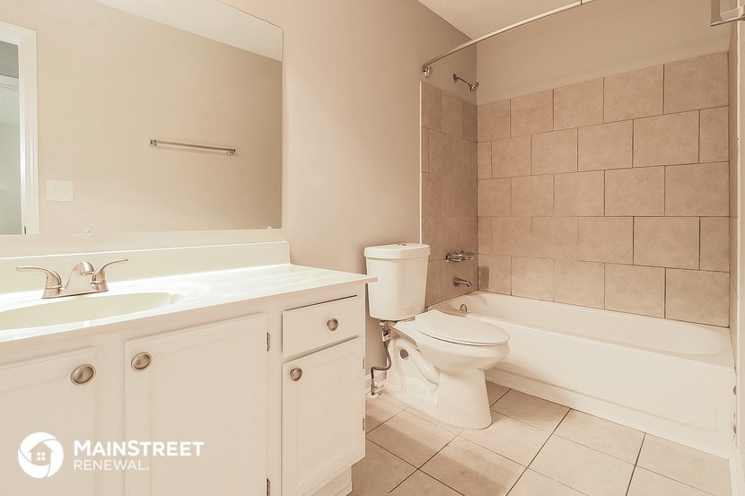 a bathroom with a sink toilet and a bath tub