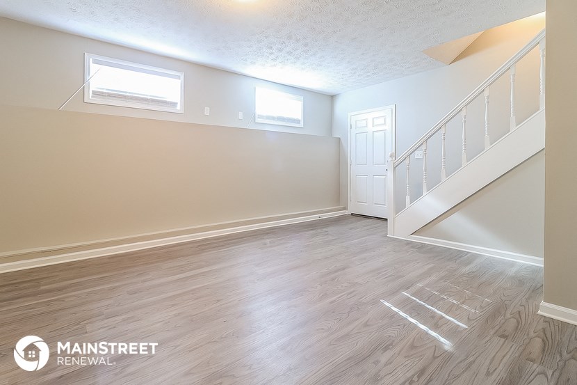 the upstairs living room with stairs to the second floor