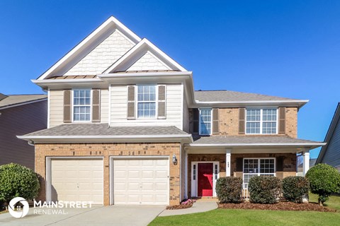 a house with two garage doors and a lawn