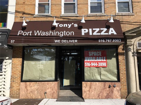 A brick building with a sign that says Tony's Port Washington Pizza.