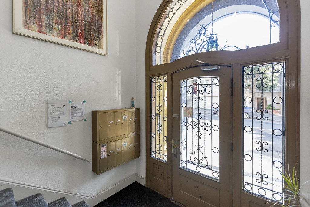 the front door of a building with a window and a mail box