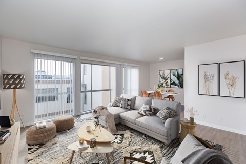 A living room with a grey couch and a wooden coffee table.