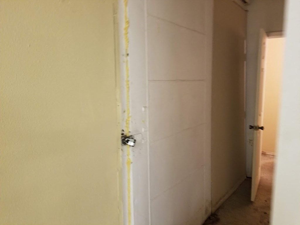 the door to the bathroom is taped off with yellow tape