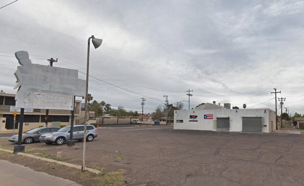 a parking lot with cars in front of an old building