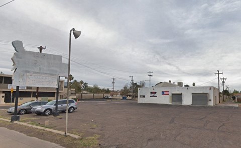 a parking lot with cars in front of an old building