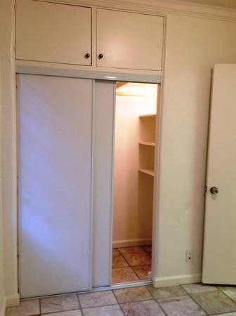a bathroom with a closet and a white door