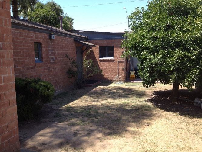 a brick house with a tree in the yard