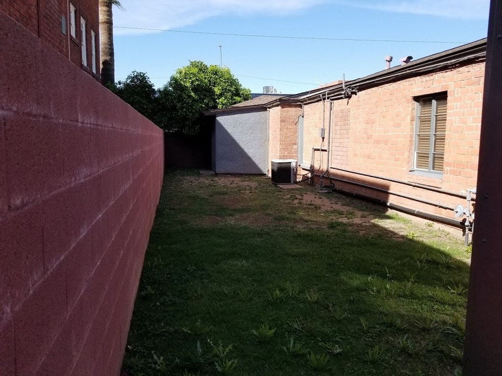 the backyard of a house with a yard and a fence