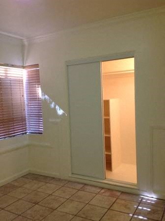 an empty room with a window and a mirror