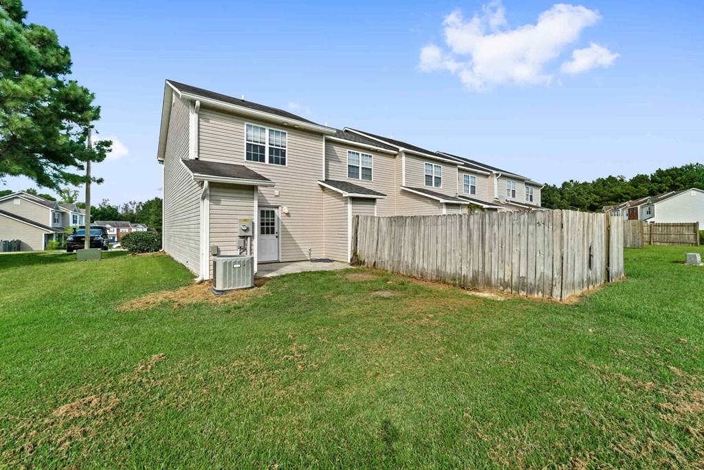 a house with a yard and a wooden fence