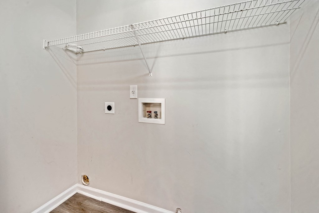 a room with a white wall and a shelf on top of it