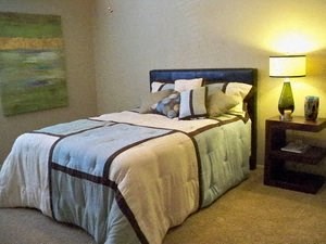a bedroom with a bed and a lamp