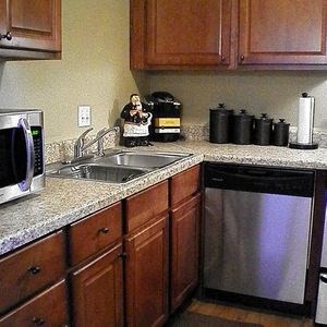 a kitchen with a stainless steel dishwasher and a sink
