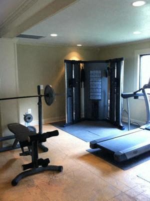 a workout room with weights and a treadmill