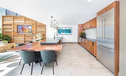 a kitchen with stainless steel appliances and a wooden table