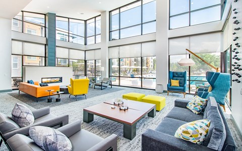 a living room with couches and chairs and a fireplace