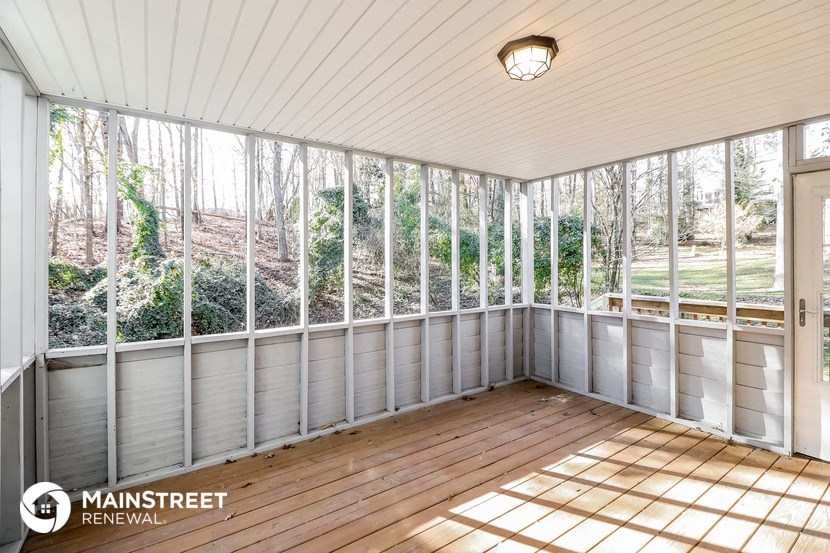 the screened porch has a view of the yard