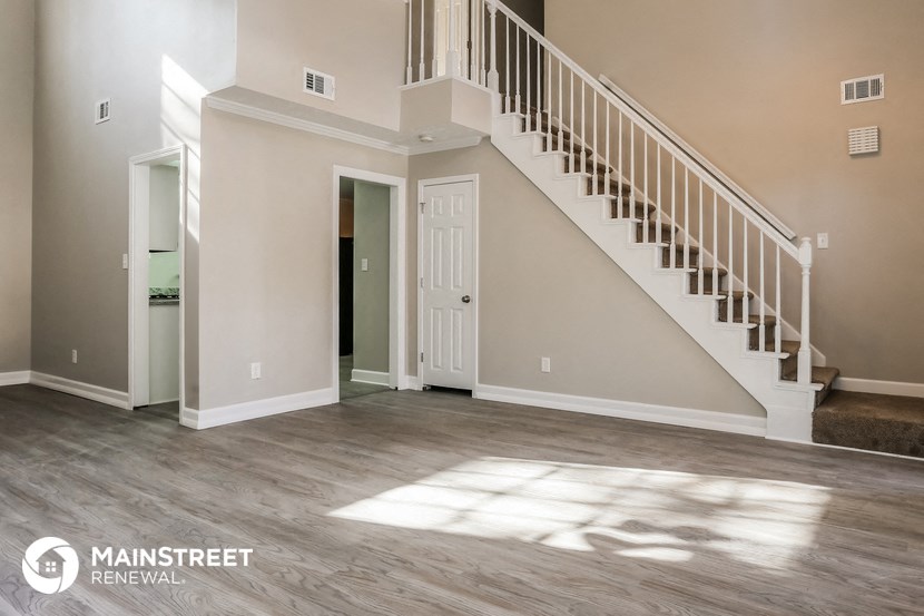the spacious living room with staircase to the second floor