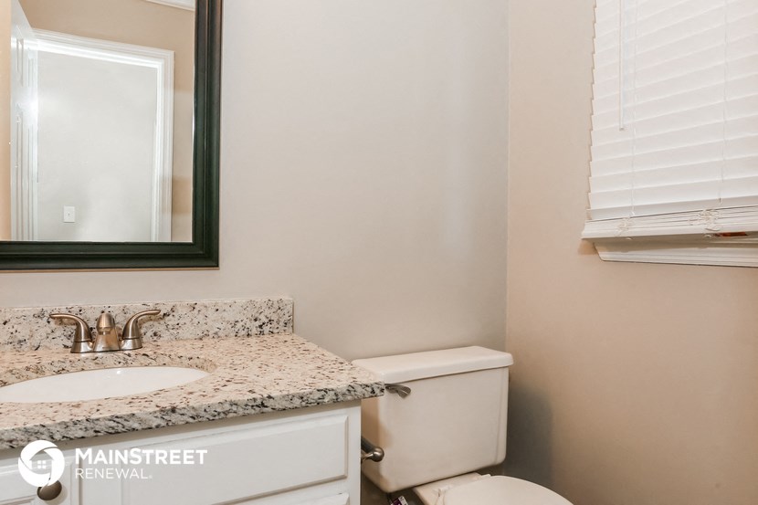 a bathroom with a sink and a toilet and a mirror