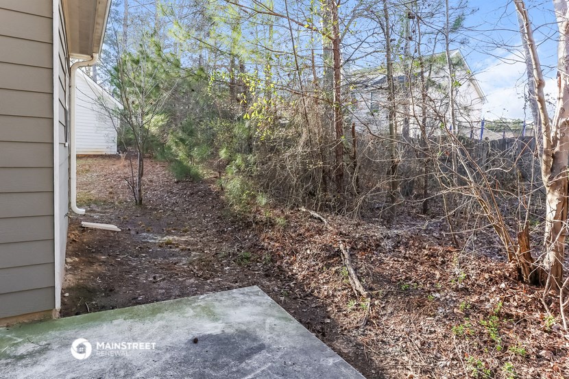 a path leading to the side of a house