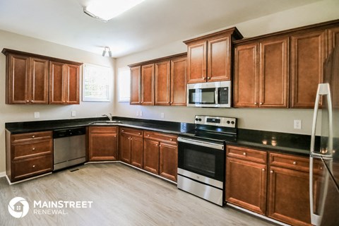 a kitchen with wooden cabinets and stainless steel appliances