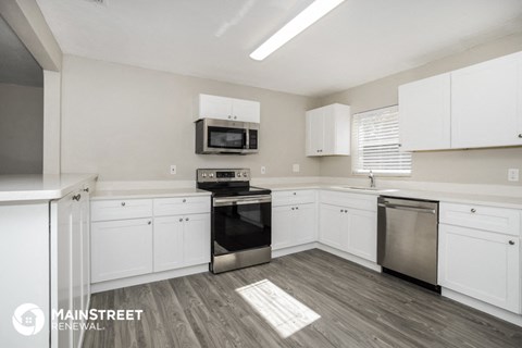 the preserve at ballantyne commons apartment kitchen with white cabinets and black appliances
