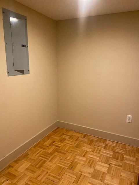 an empty room with wood flooring and a window