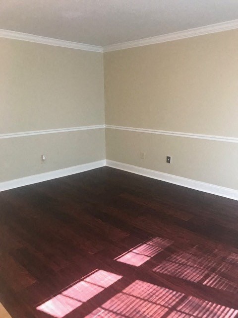 an empty room with wooden floors and white walls