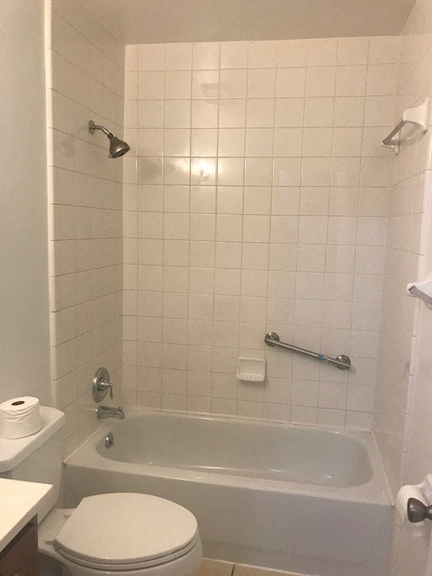 a white bathroom with a tub and a toilet