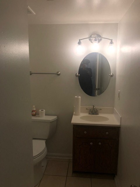 a bathroom with a toilet and a sink and a mirror