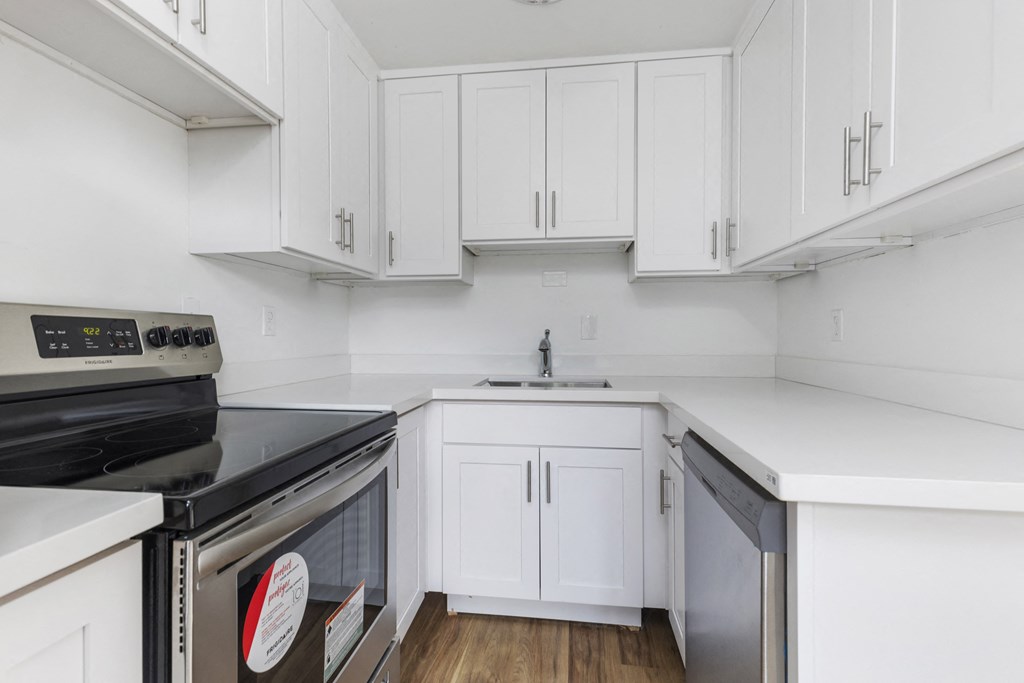 the preserve at ballantyne commons apartment kitchen with white cabinets and black appliances