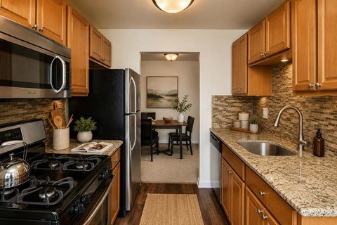 A kitchen with a black stove top oven and a black refrigerator.