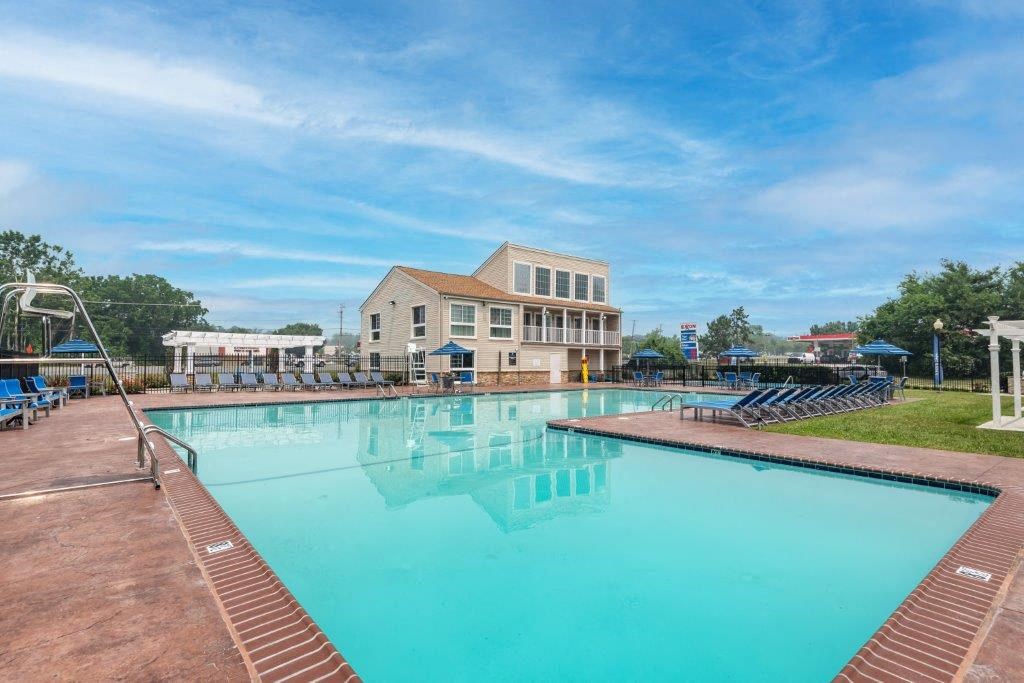 a large swimming pool with a building in the background