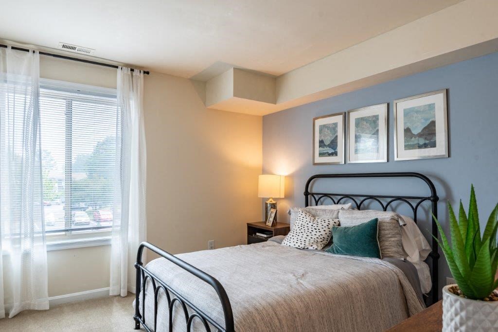 a bedroom with a bed and a window