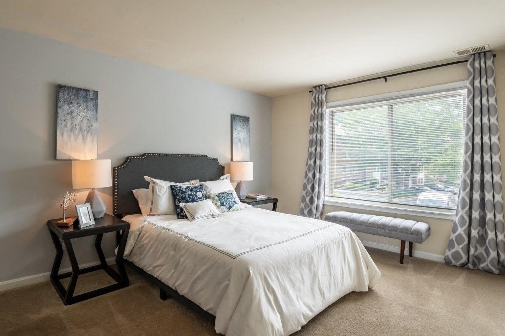 a bedroom with a bed and a window