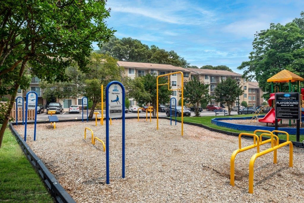 a playground in a park with a building in the background