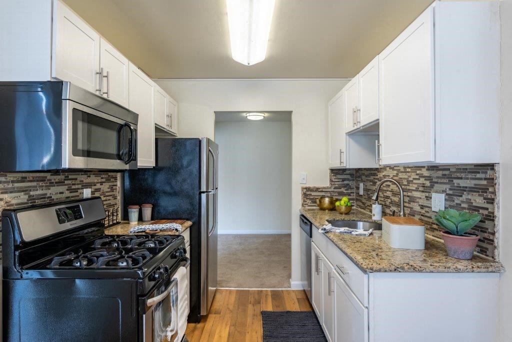 a kitchen with a stove refrigerator and a sink