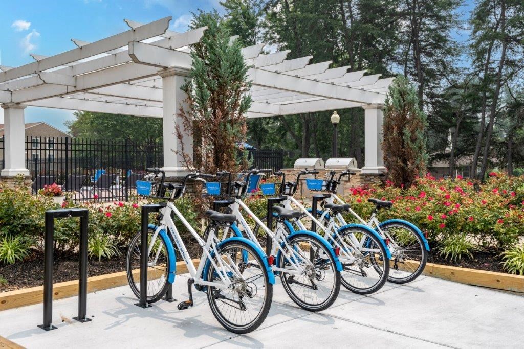 a row of bikes parked in front of a white structure