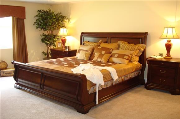 a bedroom with a bed and two lamps