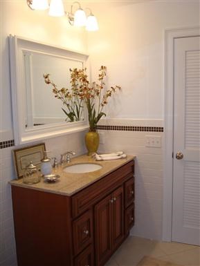 a bathroom with a sink and a vase with flowers