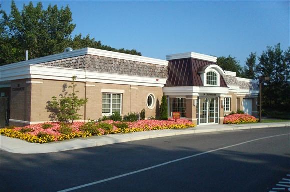 a building with a flower garden in front of it