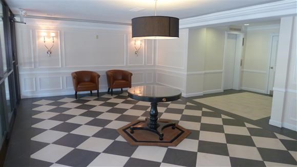 a large room with a table and two chairs