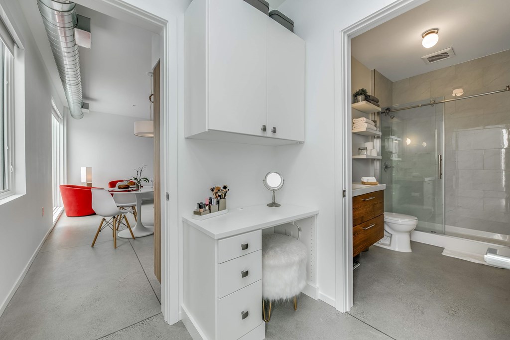 a bathroom with a vanity and a shower and a sink