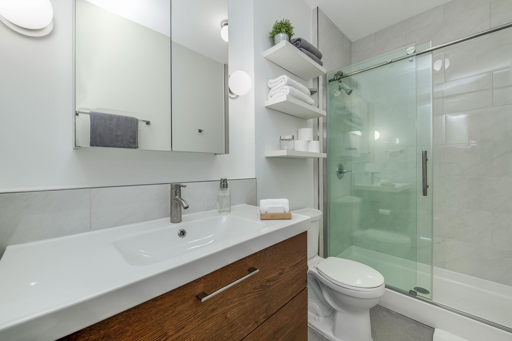 a bathroom with a sink toilet and a shower