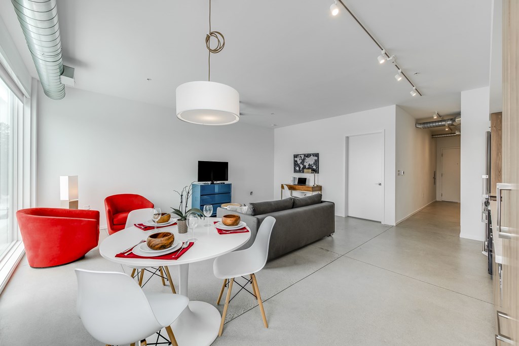 a living room with a table and chairs and a couch