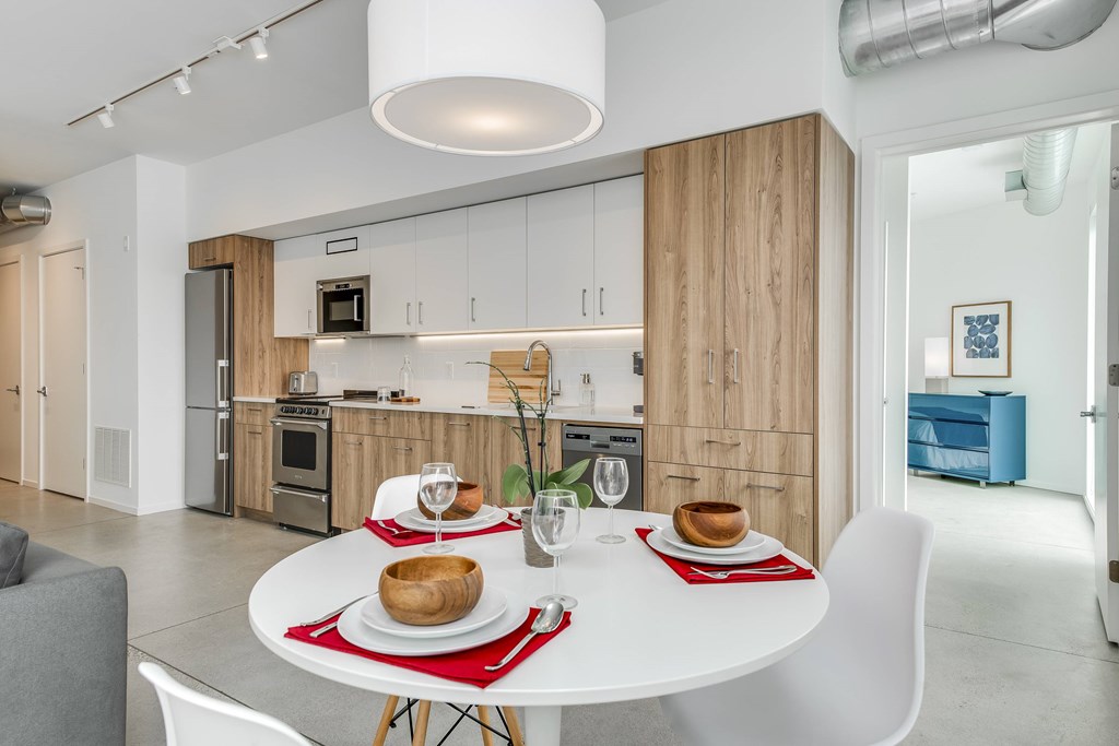 a kitchen and dining room with a table and chairs