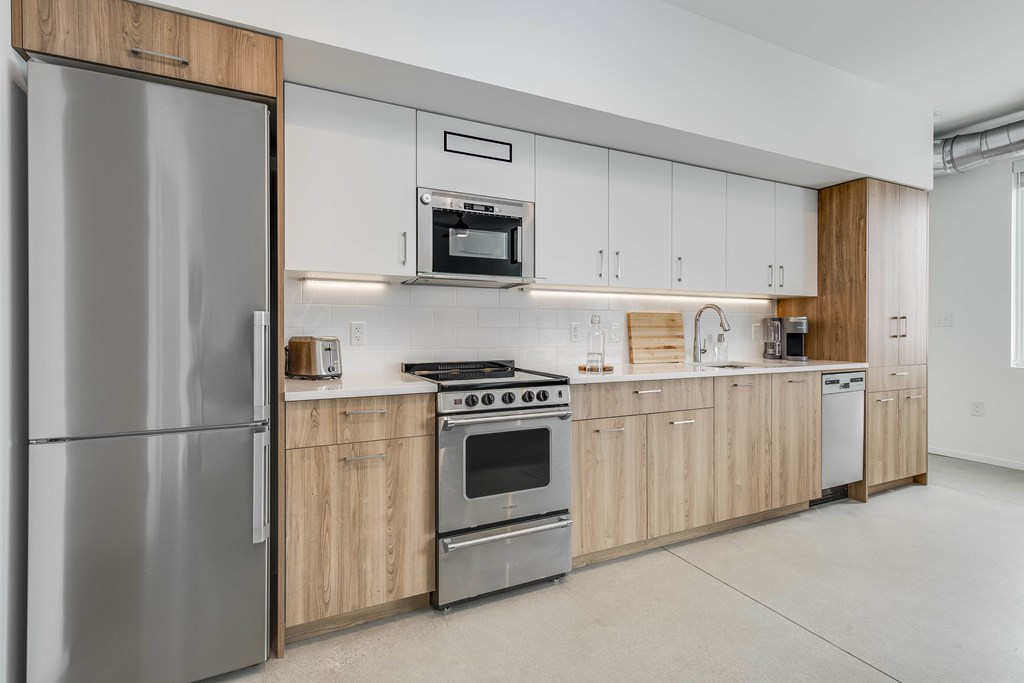 a kitchen with wooden cabinets and stainless steel appliances