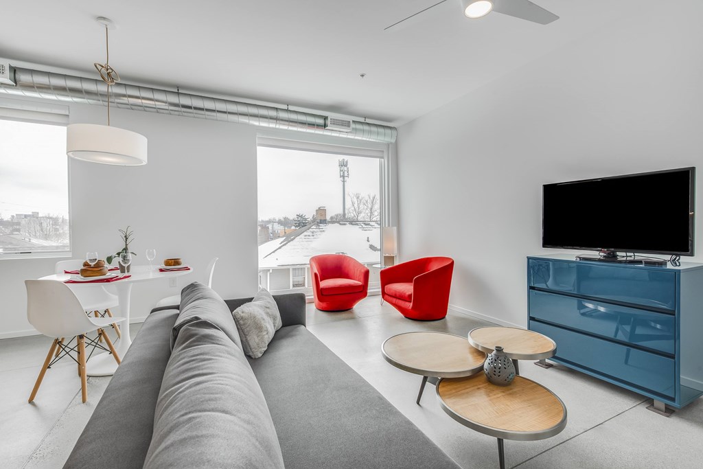 a living room with a couch and a table and a tv